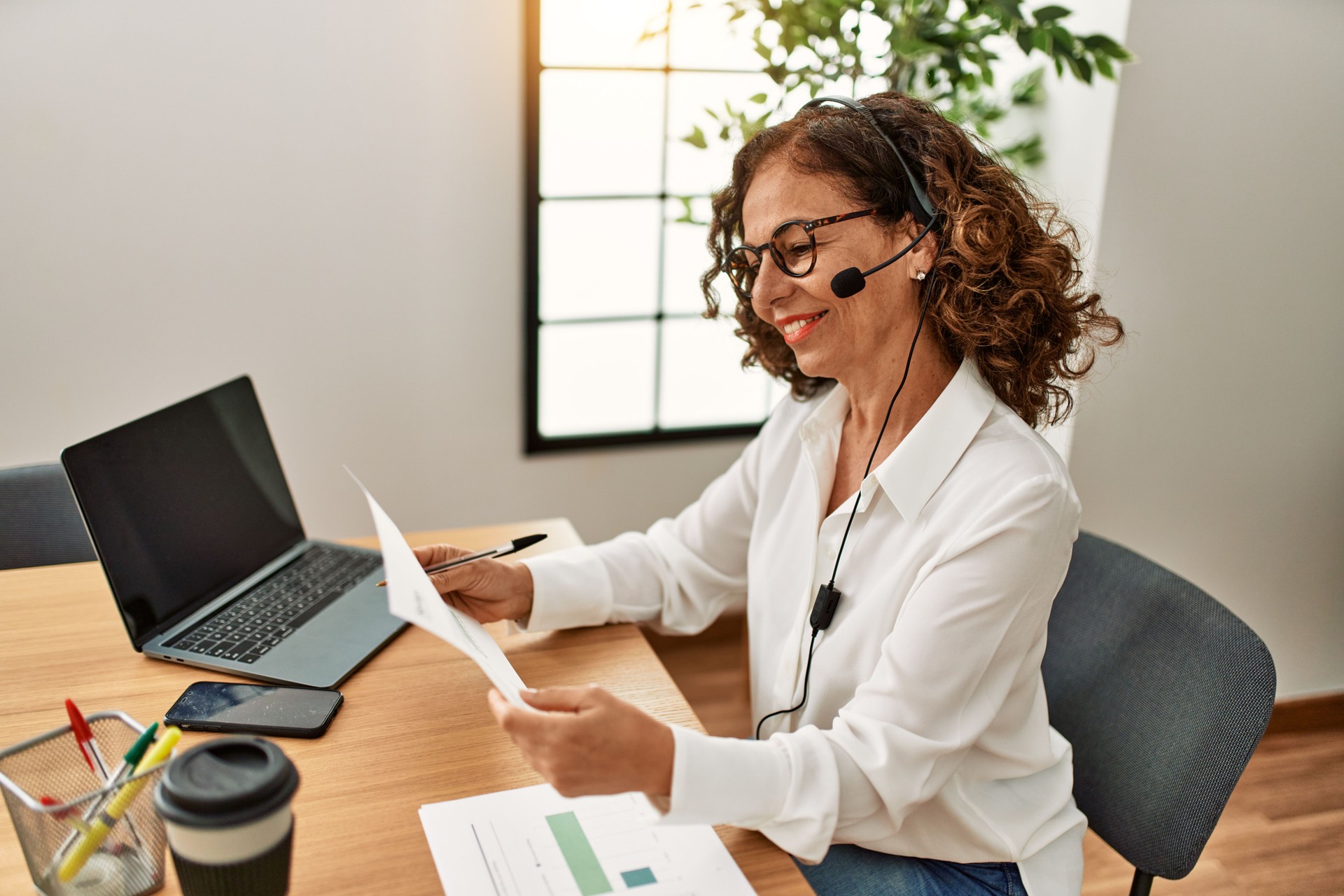 Middle age hispanic woman smiling confident working at office